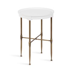 a small white table with gold legs and a round top on an isolated white background