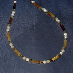 This is a beautiful beaded necklace with natural tiger's eye beads, natural mother of pearl beads and gold color brass beads. Necklace Length: about 43cm (17 Inches) + 2.5 inch extension chain Tiger's eye beads about 13mm x 4mm (0.5"x0.15"). Mother of pearl beads about 6mm (0.24"). Handmade Brown Pearl Necklace Gift, Brown Beaded Pearl Necklace For Gift, Brown Beaded Pearl Necklace Gift, Brown Round Beads Pearl Necklace Gift, Brown Single Strand Pearl Necklace For Gift, Brown Pearl Necklace With Round Beads As Gift, Brown Pearl Necklace With Round Beads For Gift, Choker Simple, Bonus Mom Gifts