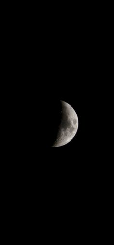 the moon is seen in the dark sky with only one light on it's side