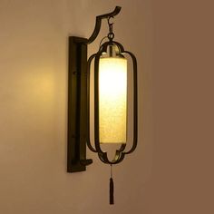 a wall mounted light with a white shade on it