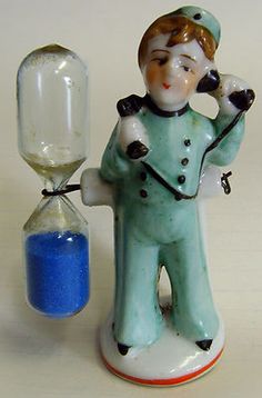 a small figurine is holding an hourglass