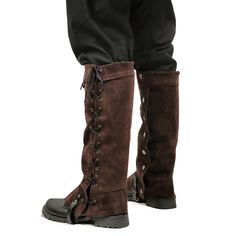 a pair of brown boots with laces on the bottom and heel, standing in front of