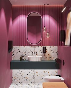 a bathroom with pink walls and black counter tops, white sink and mirror on the wall