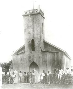 an old black and white photo of people standing in front of a church