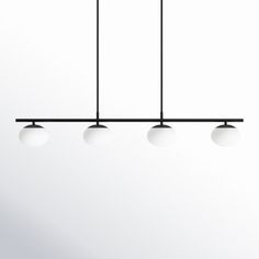 three lights are hanging from the ceiling in front of a white wall and black frame