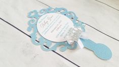 a blue and white paper cutout with a baby's name in the center