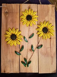 three sunflowers made out of wooden planks