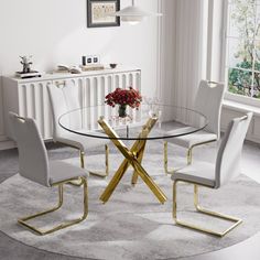 a glass dining table with white chairs and a gold cross leg chair next to it