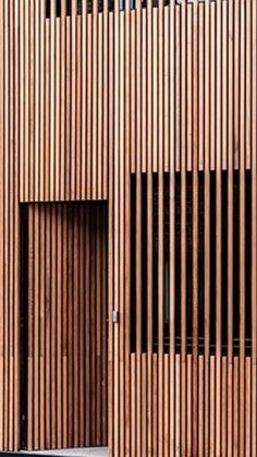 the building is made out of wood and has vertical slats on it's sides