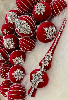 red and silver ornaments are arranged on white fur