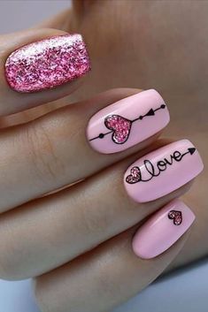 Cute pink valentines day nails with pink glittery heart shapes and word love on accent nail, and glitter pink accent nail... Mail Heart Design, Valentines Day Nails Ideas Short, Different Valentines Nails, Short Acrylic Valentines Day Nails, Valentine's Day Nail Designs Pink, Valentine’s Day Gel Nails, Valentine Gel Nails Ideas, Valentines Day Short Nails, Valentine Dip Nails