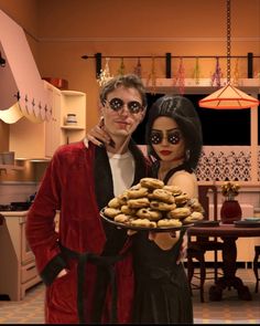 a man and woman dressed up in costumes holding doughnuts