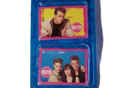 two blue plastic coasters with pictures of the cast of tv soap opera friends on them