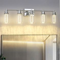 a bathroom vanity light with five lights on the side and a mirror in front of it