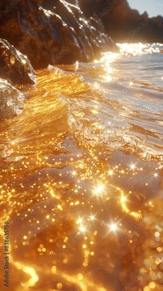 A close-up view of golden sunlight reflecting on the surface of rippling water near a rocky shoreline Honey Gold Aesthetic, Water Angel Aesthetic, Light Reflecting On Water, Liquid Gold Aesthetic, Golden Sunlight Aesthetic, Sunlight On Water, Sea Reflection, Golden Energy, Gold Abstract Wallpaper