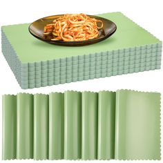 a plate of pasta on top of a green place mat