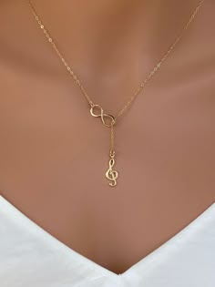 Sterling silver music charm necklace. Sterling Silver Treble Clef Music Charm. The perfect silver charm for music lovers and musicians. Sterling Silver Music Note Charm - Treble Clef 18x7mm This necklace is made of.... -18x7 S24k gold fill Music Note Charm - Treble Clef, -Gold plated on Sterling Silver infinity charm, -14k Gold Fill cable chain with spring clasp, -Come up with beautiful ribbon gift box and -One set of Care instruction package. MORE RELIGION NECKLACES https://www.etsy.com/shop/ra Music Jewelry Necklaces, Personalized Gold Music-themed Jewelry, Cheap Adjustable Music-themed Necklace, Music-themed Charm Jewelry As A Gift, Silver Music-themed Metal Necklace, Music-themed Charms Jewelry As Gift, Piano Teacher Gift, Music-themed Charms Jewelry For Gifts, Music-themed Jewelry Charms For Gifts