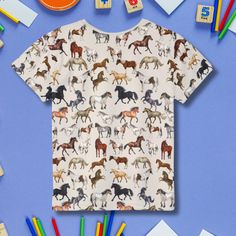 Get ready for adventure on the farm with our adorable Horse T-Shirt designed specifically for kids! Featuring a delightful cute horse pattern, this comfortable tee is perfect for little horse lovers who want to express their passion for horses. Made from heavyweight cotton, it provides a soft feel and durability for all-day wear, whether they're playing outside, heading to a horse riding lesson, or enjoying a casual day at home.  This shirt makes for a thoughtful gift for horse owners or a fantastic surprise for birthdays and other special occasions. Not only is it a practical addition to your child's wardrobe, but it's also a fun way to celebrate their love for horses! Care Instructions: To keep your kids horse t-shirt looking fresh and vibrant, machine wash in cold water with similar col Playful T-shirt With All Over Print And Short Sleeves, Casual Short-sleeved T-shirt With Horse Design, Casual Short Sleeve T-shirt With Horse Design, Casual Short Sleeve Tops With Horse Design, Short Sleeve Cotton Top With Horse Design, Casual Cotton T-shirt With Horse Design, Cotton Short Sleeve Top With Horse Design, Riding Lessons, Horse Pattern