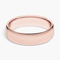 a rose gold wedding ring on a white background