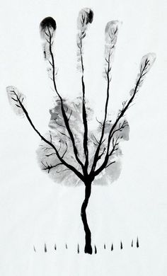 a black and white photo of a tree in the snow