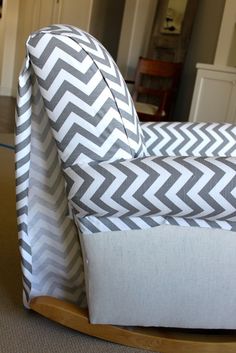 a grey and white chevroned couch in a living room