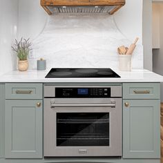 a stove top oven sitting inside of a kitchen next to an oven with two burners