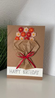 a birthday card with flowers in a vase