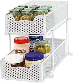 three tiered spice rack with spices and condiments in white metal mesh baskets