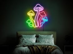 a bedroom with a bed and neon mushrooms on the wall