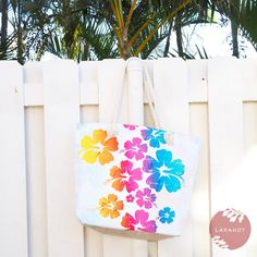 Go Aloha with this handy canvas tote bag. Vibing with the Aloha spirit, this spacious bag folds up easily and can hold a lot when you want it to. We're loving the versatility & island Hawaiian vibe of this tote bag. Perfect for stashing our goodies shopping or filled our fave farmer's market finds. Canvas with printed hibiscus flowers design on front & back Lined Zipper closure with internal pocket Twisted rope double handle strap Bag: H15" x W20" x 6 1/2"D Bag: 7" handle drop This is an all sales final item - no return. White Tropical Bag For Everyday Use, White Tropical Beach Bag For Everyday Use, White Tropical Beach Bag, Pali Hawaii Sandals, Aloha Spirit, Strap Bag, Island Vibes, Flowers Design, Farmer's Market