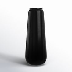 a black vase sitting on top of a white table