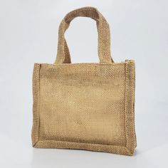 a jute bag is shown on a white background, with the handle down to it's side