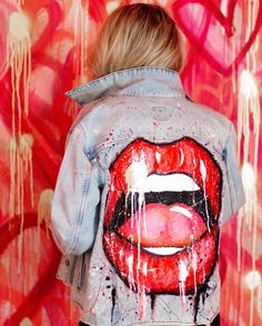 a woman with red lipstick painted on her jacket