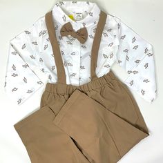 Adorable Baby Boy Outfit, New With Tags, Featuring A Dressy Shirt With Dinosaur Print And Bow Tie And Coordinating Pants With Suspenders. Super Sweet For Special Occasions, Weddings, Church, Events Etc. Tan Khaki Dino I Have Many Many Baby And Kids Items In My Store, Including Another Identical Set Perfect For Boy Twins, Cousins Or Besties. Bundle And Save! Spring Dress-up Sets In White, White Dress-up Sets For Spring, White Cotton Dress-up Set, Cute White Dress-up Sets, White Long Sleeve Sets For First Birthday, White Long Sleeve Set For First Birthday, Fitted White Sets For Dress-up, White Fitted Sets For Dress-up, White Long Sleeve Dress-up Sets