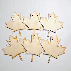 wooden maple leaf cutouts on white background