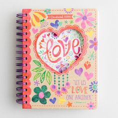 a notebook with the word love written on it and colorful flowers in the pages,