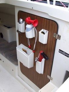 the inside of a boat with several different items on it's back wall and storage compartments