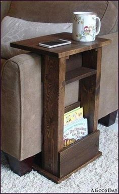 a coffee table with a book shelf underneath it and a cup sitting on top of it