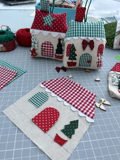 several small christmas gift bags sitting on top of a table