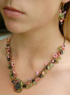 This is a necklace and earring set, a complex medley of pink flowers, pink flowers and hearts, and olive green leaves.  A matching black rose cameo with a pink and green background hangs from this lovely necklace. I find the flowers and leaves display better on this particular type of chain, they display forward against the body, whereas cable chain does not display as perfectly.  Notice how the necklace lays against the model's neck.  It didn't have to be arranged to look that perfect, it falls Pink And Green Background, Green Necklaces, Cascade Design, Flowers And Hearts, Bell Flowers, Beads Work, Green Beaded Necklace, Lovely Lavender, Purple Accents