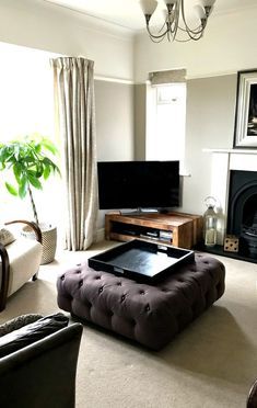 a living room filled with furniture and a flat screen tv on top of a wooden stand