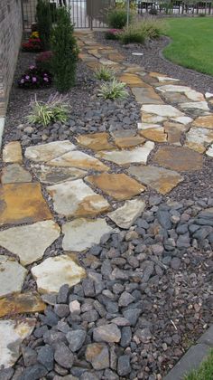 a stone path in front of a house