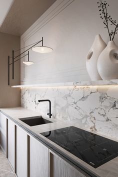 a kitchen with marble counter tops and white vases on the wall above it's sink