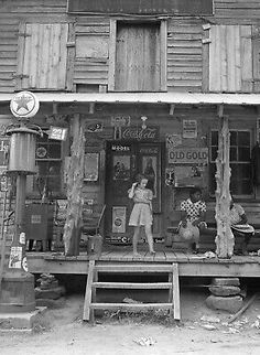 an old black and white photo of a store front