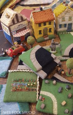 a table topped with lots of small toy houses