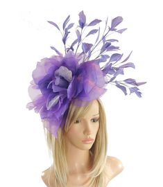 Hats By Cressida Ascot Fascinators, Wedding Hats & Kentucky Derby Hats Purple & Lilac Hayley Feather and Silk Fascinator Hat A mass of purple feathers surround a large purple silk rose flower Flower is about 10 inches wide, feathers about 8-10 inches We can do this in many colours Mounted with a matching headband. If you prefer a headband to match your hair, please make a note at check out what colour headband you want. The Hayley Fascinator Hat is perfect for any special occasion, whether it's a glamorous horse race like the Kentucky Derby or a formal affair like Royal Ascot. This stunning hat features a large silk rose flower, surrounded by a gorgeous mass of feathers, making it a truly elegant headpiece. It's perfect for the mother of the bride or any woman in need of a formal hat. The Purple Hats For Royal Ascot Races, Fitted Purple Hat For Kentucky Derby, Purple Fascinator For Royal Ascot, Purple Fascinator For Royal Ascot Races, Purple Hat Headpieces For Kentucky Derby, Purple Headband For Kentucky Derby, Purple Hat For Royal Ascot, Purple Headpieces For Spring Races, Purple Headpieces For Races