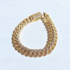 Get ready to sparkle with our Gold Diamond Cuban Link Bracelet dipped in real 18k gold. The perfect gift for a special someone, or simply treat yourself to some bling! An elegant, unique piece that many women would love to add to their collection. ✔Hypoallergenic ✔Water Resistant ✔Quality Guaranteed ✔Handmade Size: 7 inches length, 10mm width Material: 18k gold plated Yellow Gold Bracelets With Adjustable Chain And Cubic Zirconia, Adjustable Gold Cubic Zirconia Bracelets, Cubic Zirconia Chain Bangle Bracelet As Gift, Gold Cubic Zirconia Bangle Bracelet, Adjustable Cuban Link Gold Chain Bracelet As Gift, Gold Bangle Crystal Bracelet With Adjustable Chain, Gold Crystal Bangle Bracelet With Adjustable Chain, Cuban Link Bling Bracelets For Party, Diamond Chain Bracelet Tarnish Resistant As Gift