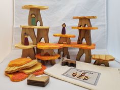 a group of wooden toys sitting on top of a white table next to each other