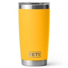 a yellow yeti tumbler cup with the word yeti written in silver on it