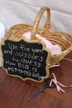 a sign that says use the yarn and scissors to guess how big is mommy's baby